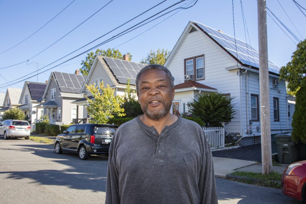 Melvin standing on the street outside their home