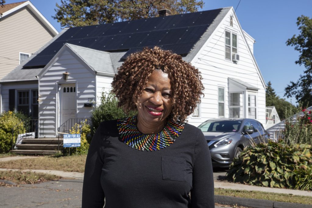 Coretta smiling outside their home